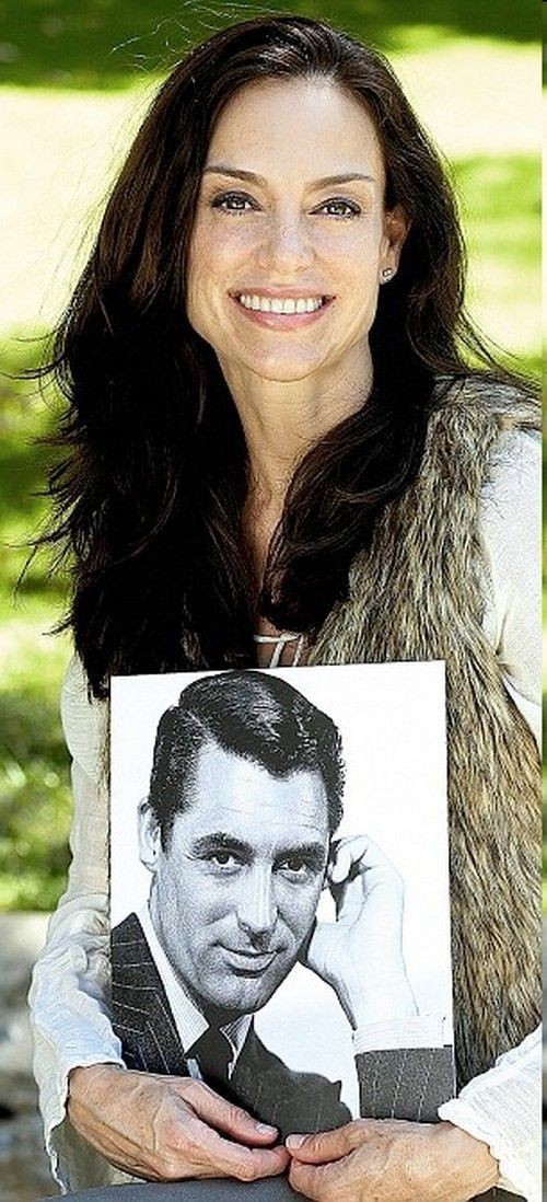 Jennifer Grant holding a picture of her legendary father, Cary Grant.